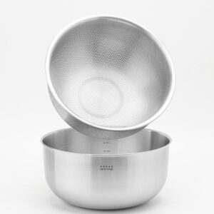 Stainless steel mixing bowl with a strainer, perfect for kitchen use and food preparation.