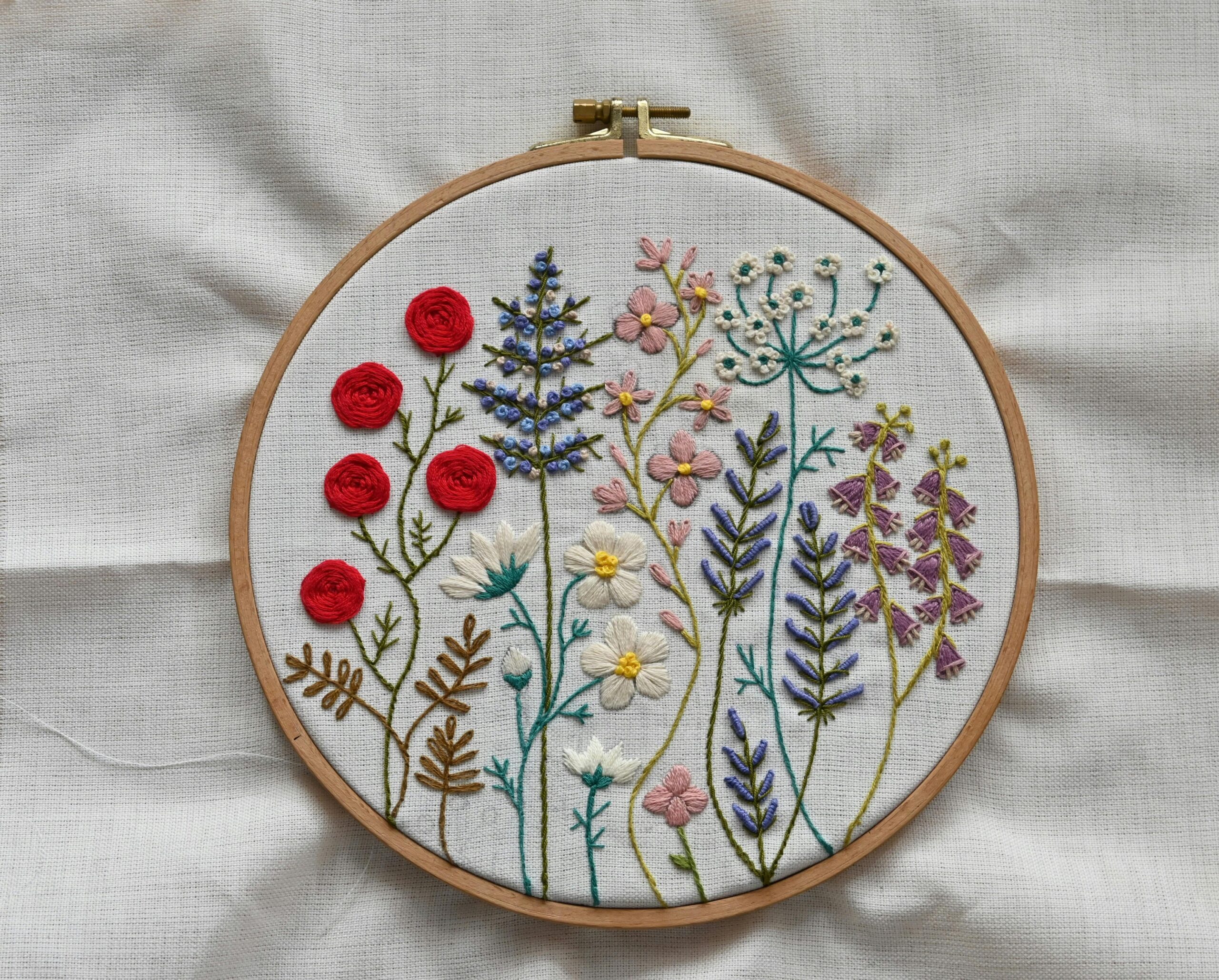 pexels photo 35360708 35360708 Vibrant handcrafted floral embroidery showcased in a wooden hoop on fabric.
